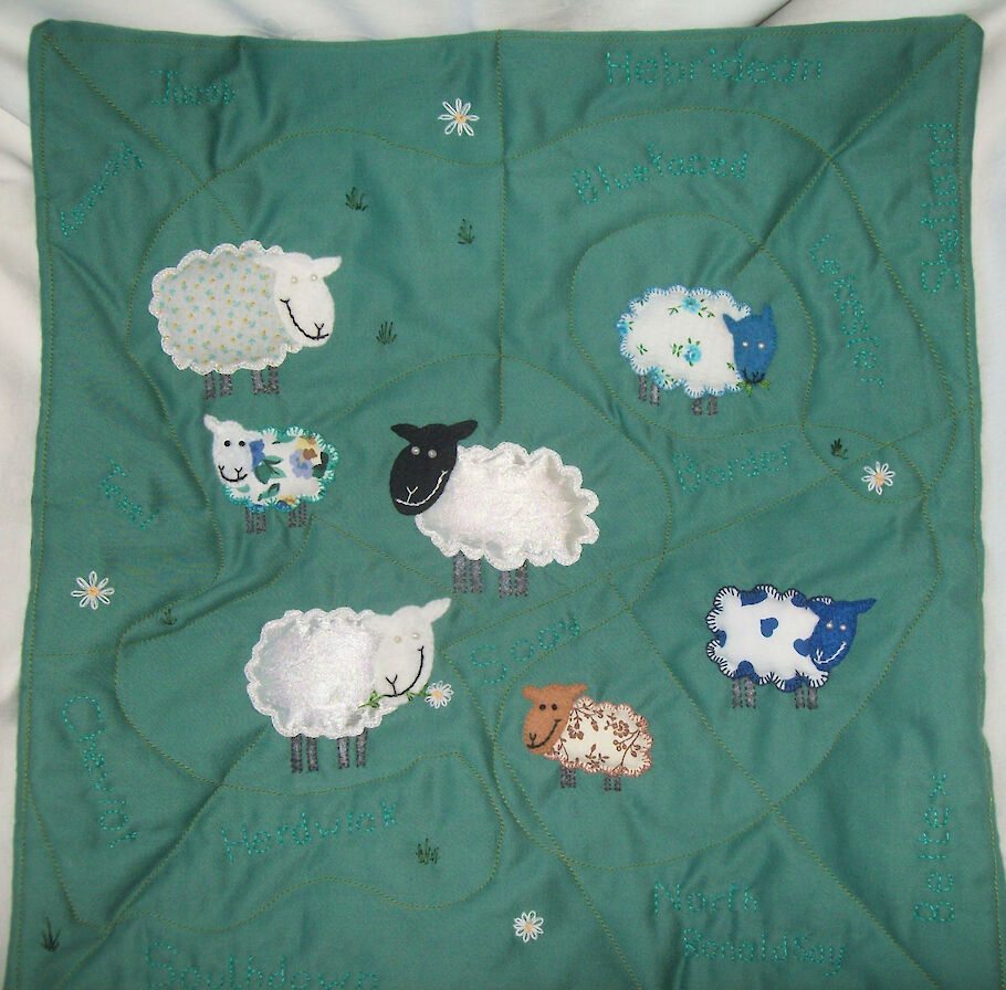 Quilted, applique and embroidered cushion 'Counting Sheep'.