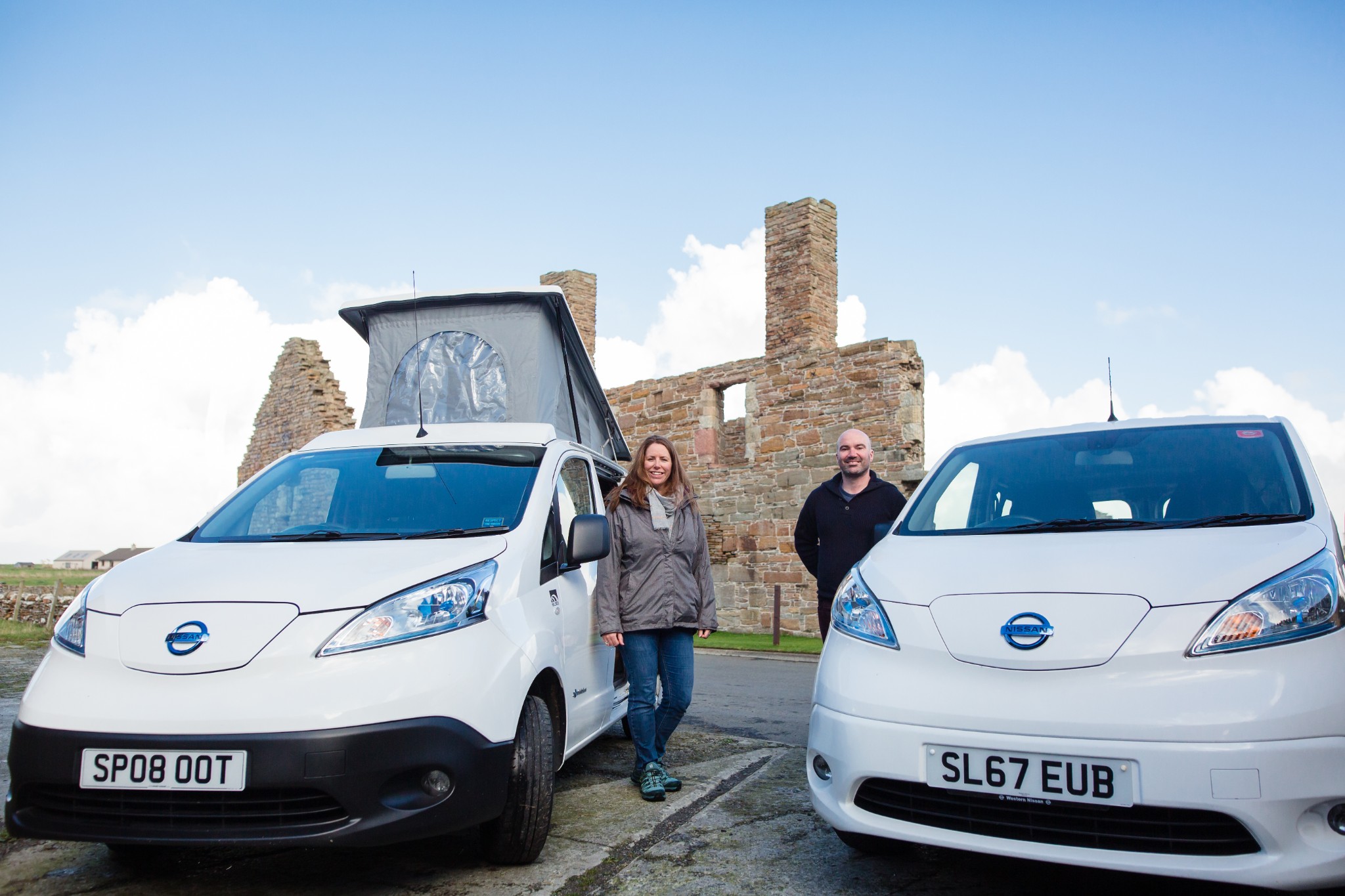 Jane and Paul with their electric vehicle fleet