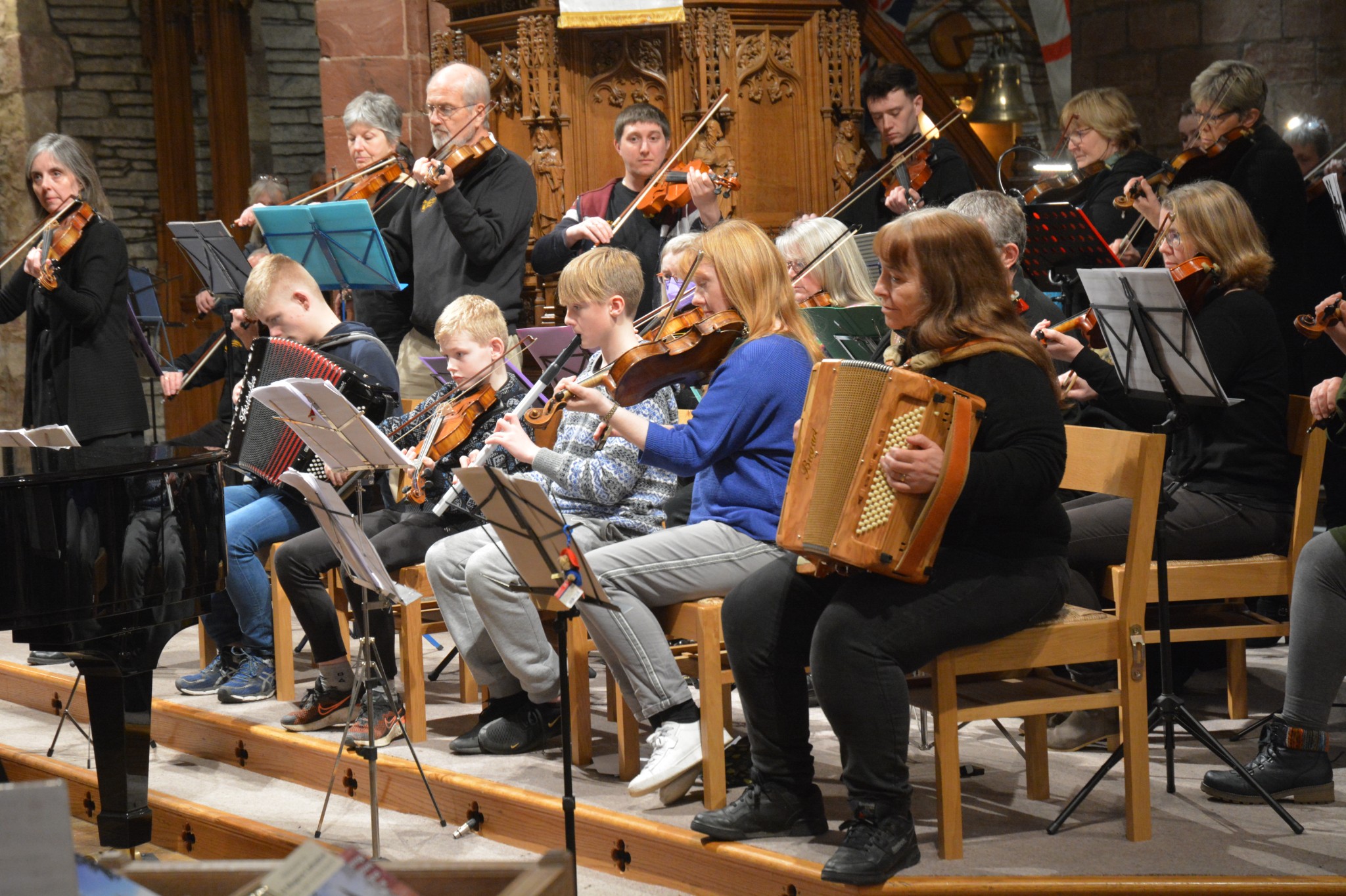Richard's partner Bev (back right), playing at the back at a concert in St Magnus Cathedral