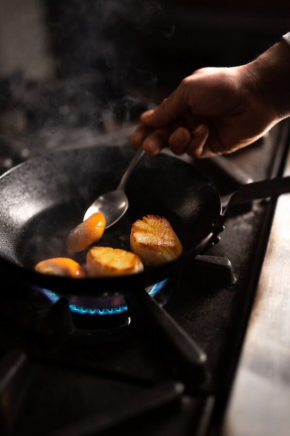 Fresh Orkney scallops being cooked at the Hamnavoe Restaurant, Stromness